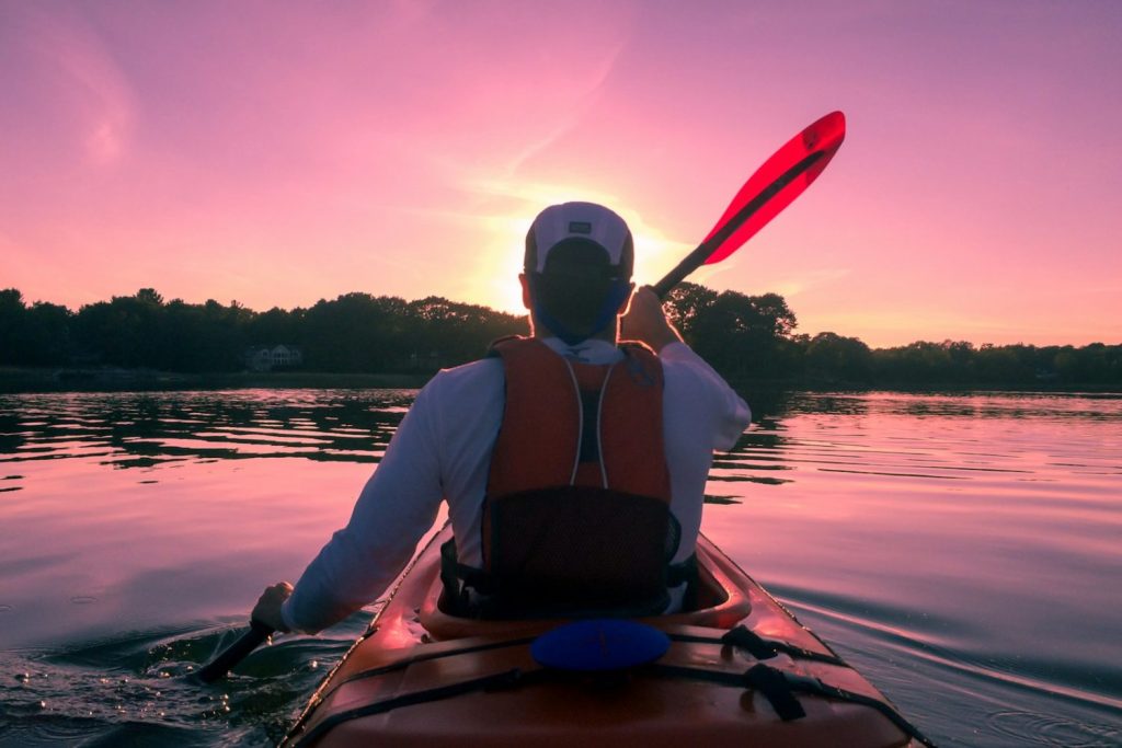 man riding on kayak